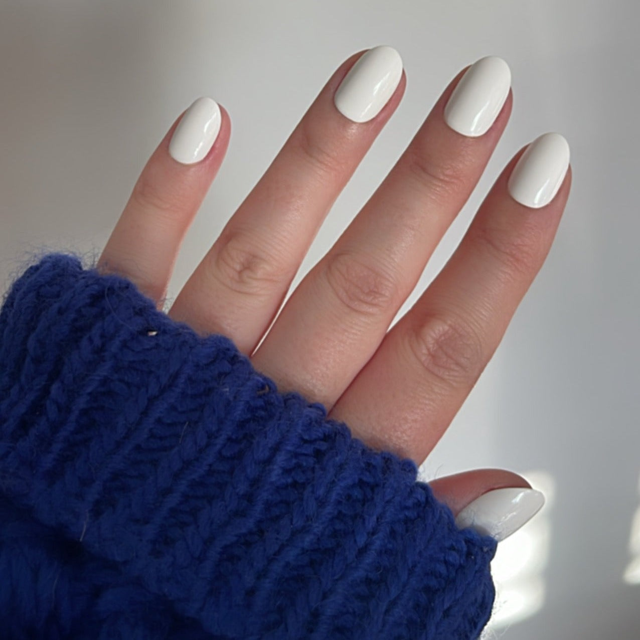 Girl wearing Instant Mani Co. Coconut Crush white short round press on nails