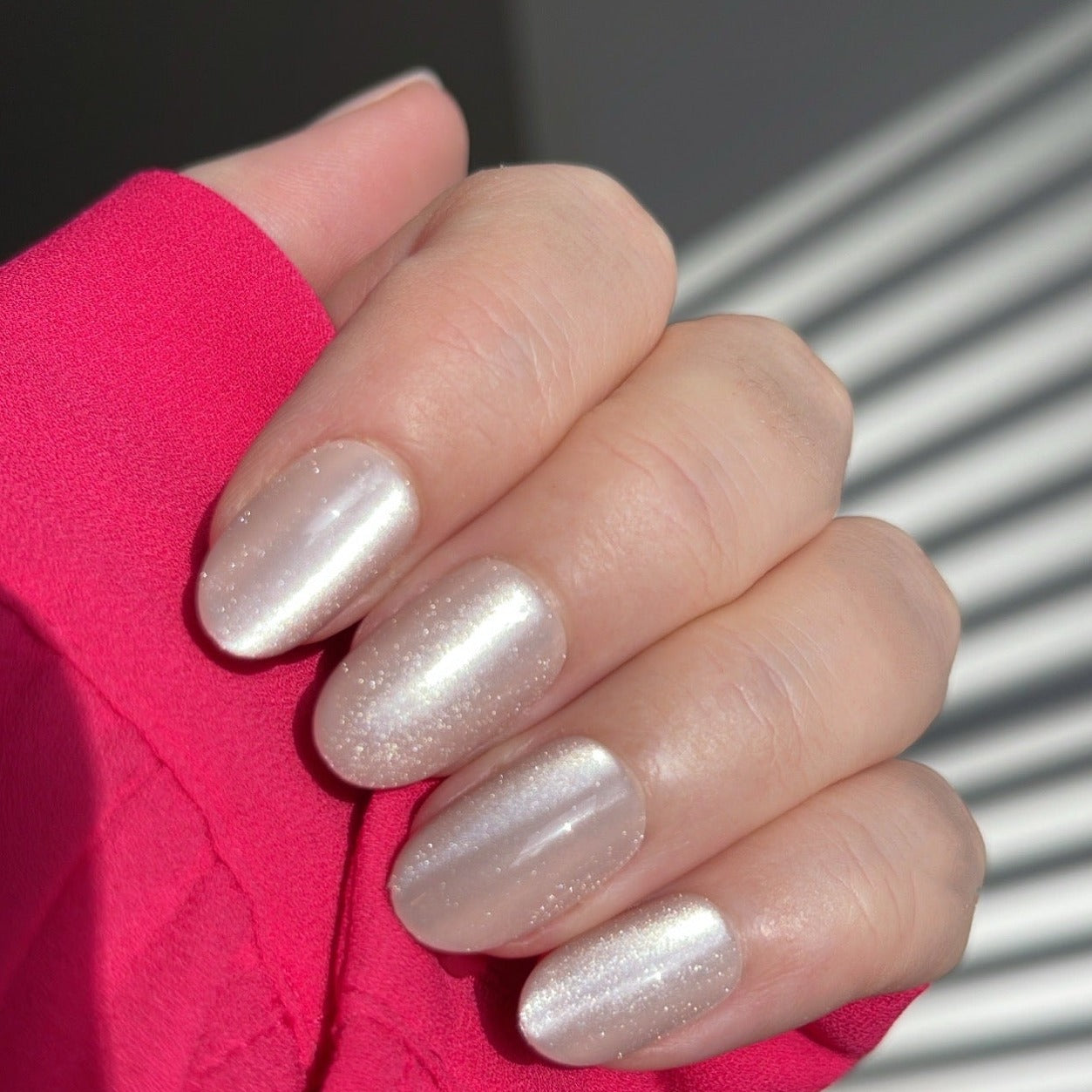 Girl wearing long sleeve pink top and Instant Mani Co. Golden Hour velvet press on nails